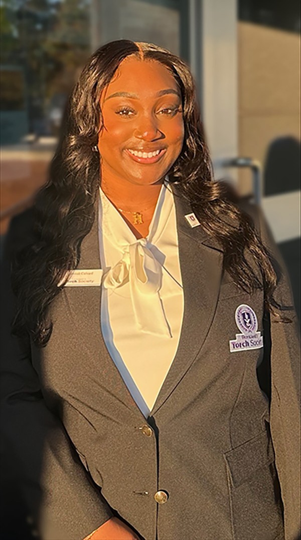 Photo of MGA student, Hannah Colvard, wearing her President's Torch Society uniform.